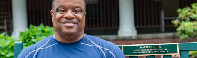 Image of Terry S. sitting on a bench outside of Asbury Heights