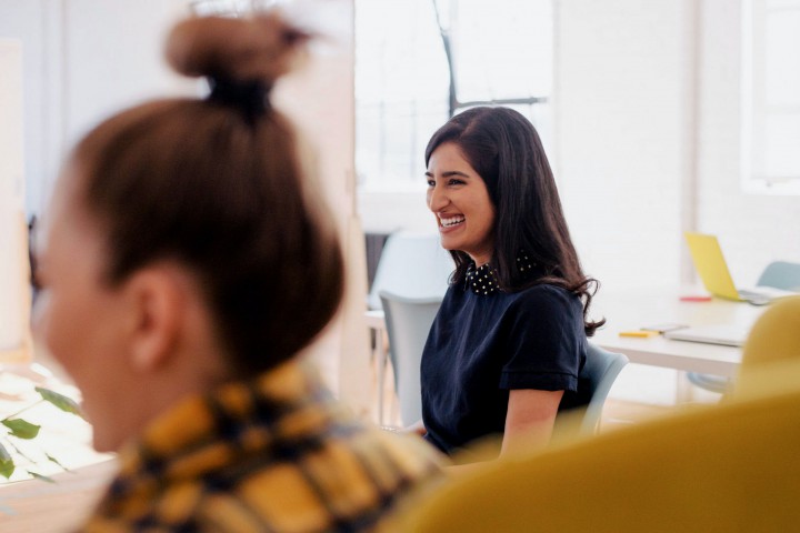 Smiling women in a meeting.