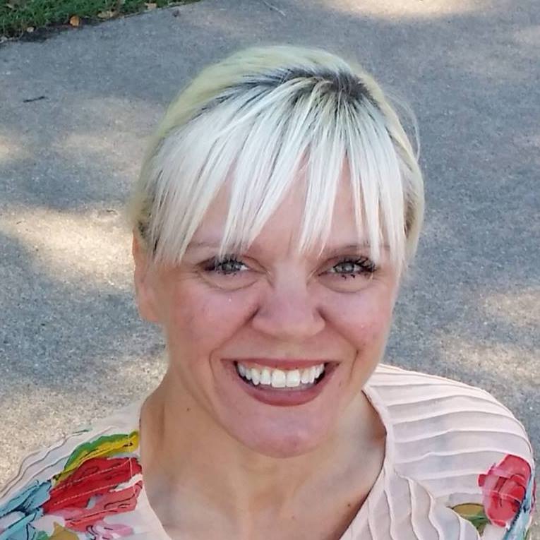 Smiling woman with blonde hair.