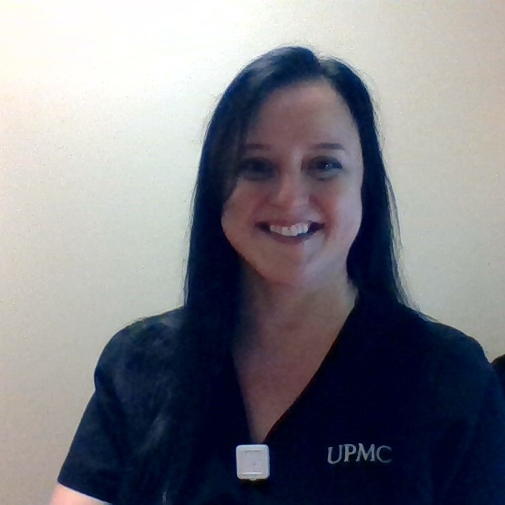 Woman with dark hair smiling.