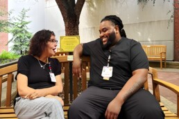 Jacoby and Amy sitting on a bench.
