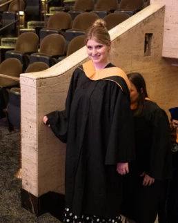 Woman in graduation robes as a instructor.