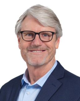 Headshot of a smiling man in a sportcoat.