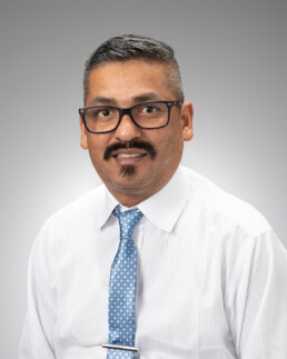 Headshot of a man in professional dress clothes.